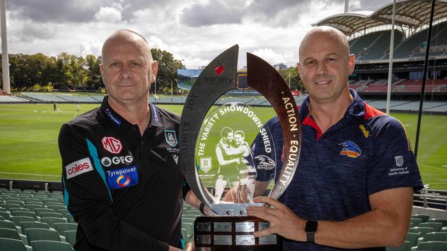 AFL Port Adelaide Football Club Coach Ken Hinkley and Adelaide Football Club Coach Matthew Nicks hold the Showdown Trophy ahead of Showdown 53 at Adelaide Oval, SA. Picture: Emma Brasier