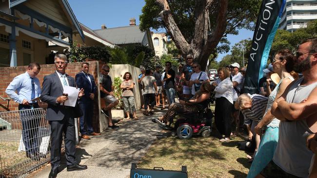 John Cunningham leads the auction of 91 Darley Street, Manly. The auction attracted plenty of attention and buyers were not even deterred by the outdoor dunny in completely original condition.