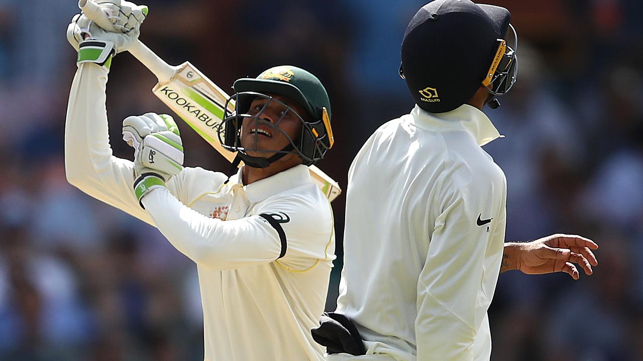 Usman Khawaja of Australia hits a shot in the air off Ravi Ashwin and is caught out.