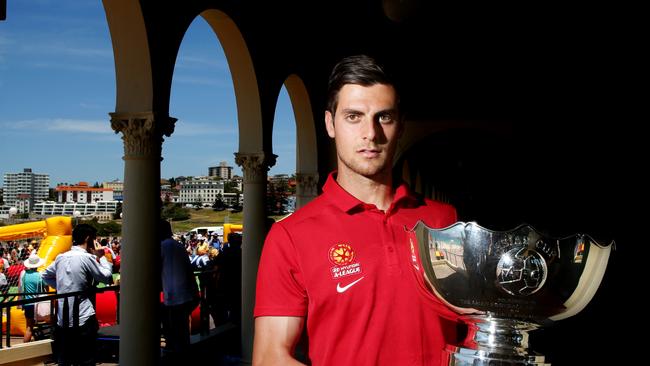 Wanderers Tom Juric with the Asian Cup trophy at Bondi Beach , Bondi .Picture Gregg Porteous