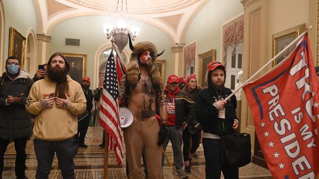 Trump supporters including member of the QAnon conspiracy group Jake Angeli, aka Yellowstone Wolf (C), enter the US Capitol in Washington on January 6 2021. Picture: AFP.