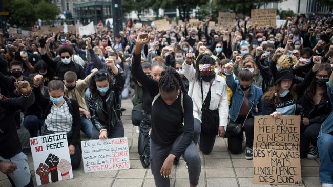 People raise their fist and stand on their knees as they demonstrate in Nantes. Picture: AFP