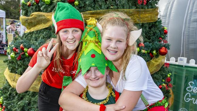 Helen Hungerford, Madison Page and Amy Farrell pose for a photograph at Caboolture Christmas Carols, Sunday, November 24, 2019 (AAP Image/Richard Walker)