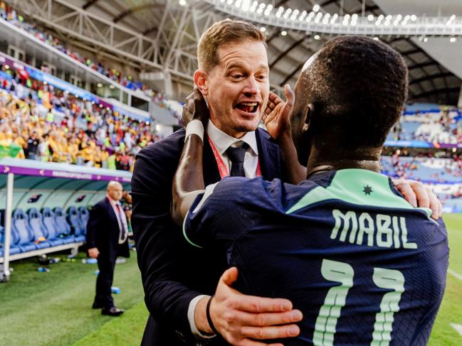 Paddy Steinfort celebrates with Socceroos star Awer Mabil at the FIFA World Cup in Qatar.