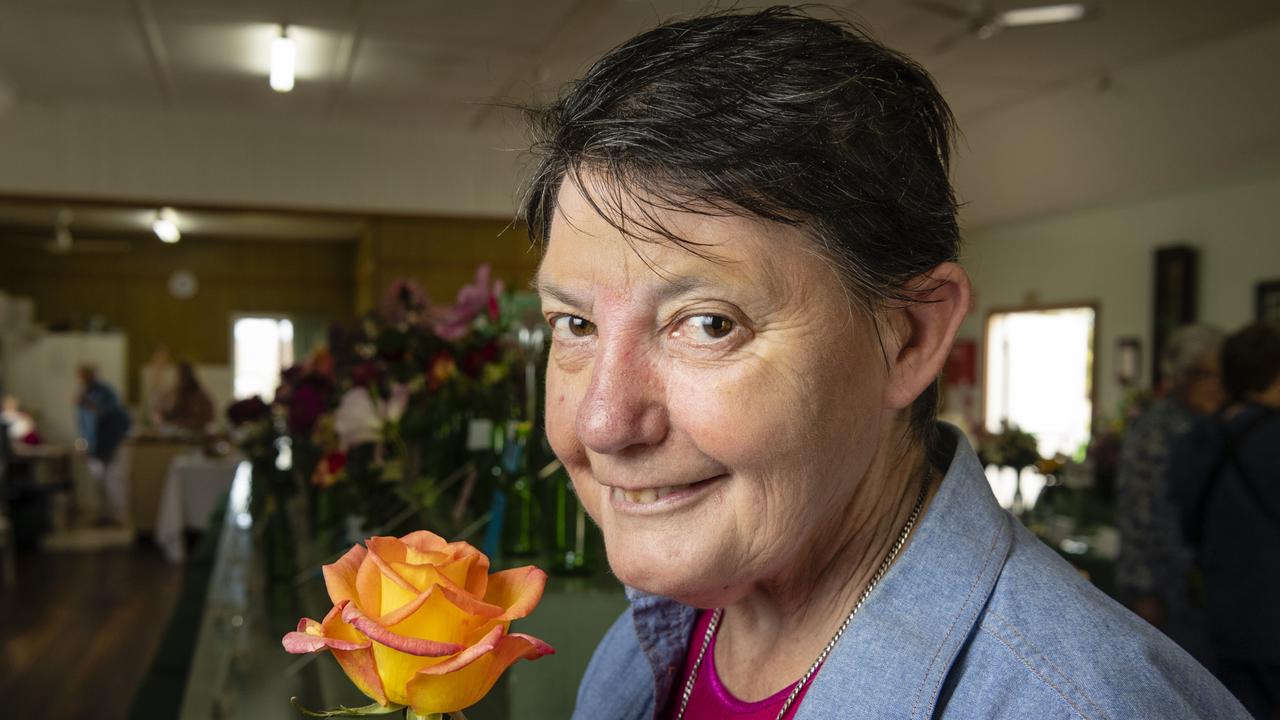 Susanne Dart shows off her hybrid tea reserve champion of the 2022 Spring Champion Rose Show at the Rose Cottage in the Queensland State Rose Garden, Saturday, October 8, 2022. Picture: Kevin Farmer