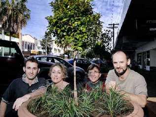 looking good: Magellan Street business owners and employees Aaron Hughes head chef of the Mecca, Christine Shearman part owner of Making Faces, Beverley Tainsh of Magellan Rose and Mark Muss of Just Grounds Cafe on Woodlark with potted trees purchased from the council. . Picture: Jay Cronan