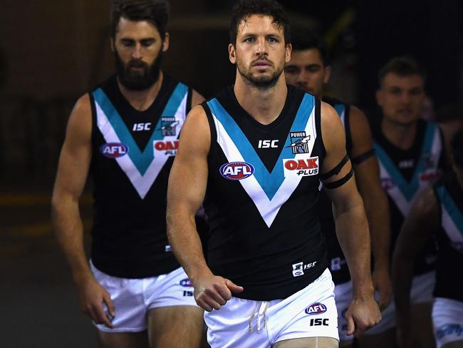 Travis Boak of the Power leads his team out onto the field.