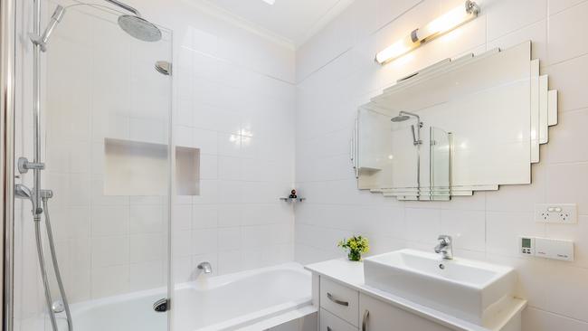 The updated bathroom with its striking Art Deco mirror.