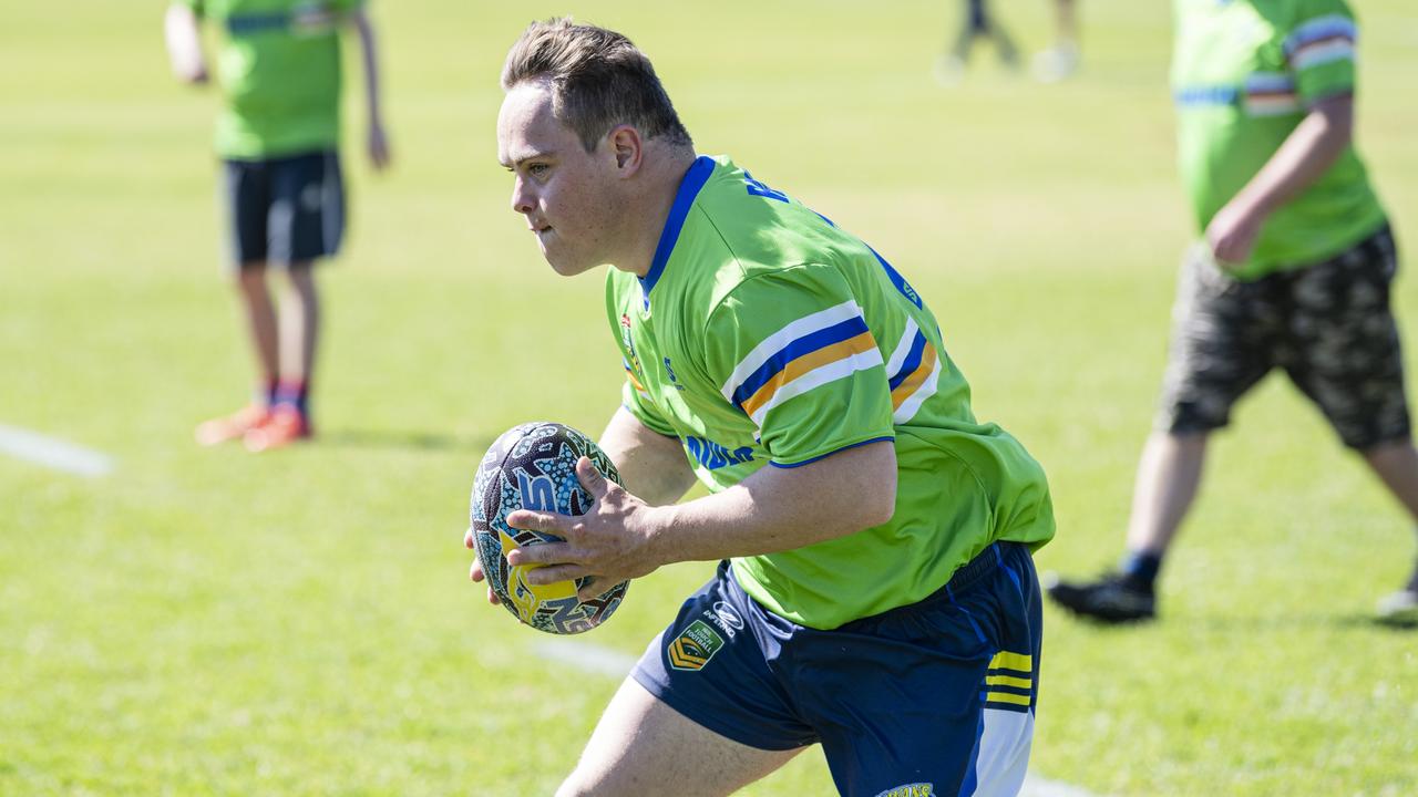 Raiders player James Laffy takes on the Cowboys line in the All Ages All Abilities Toowoomba Touch grand final at Kearneys Spring Sporting Complex. Picture: Kevin Farmer