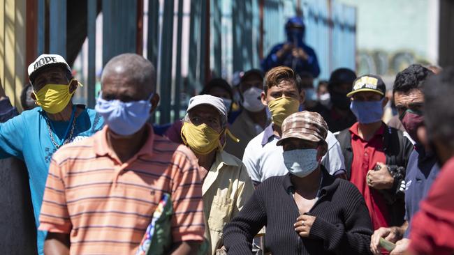 While some Venezuelans party, others queue for hours for petrol. Picture: Getty Images