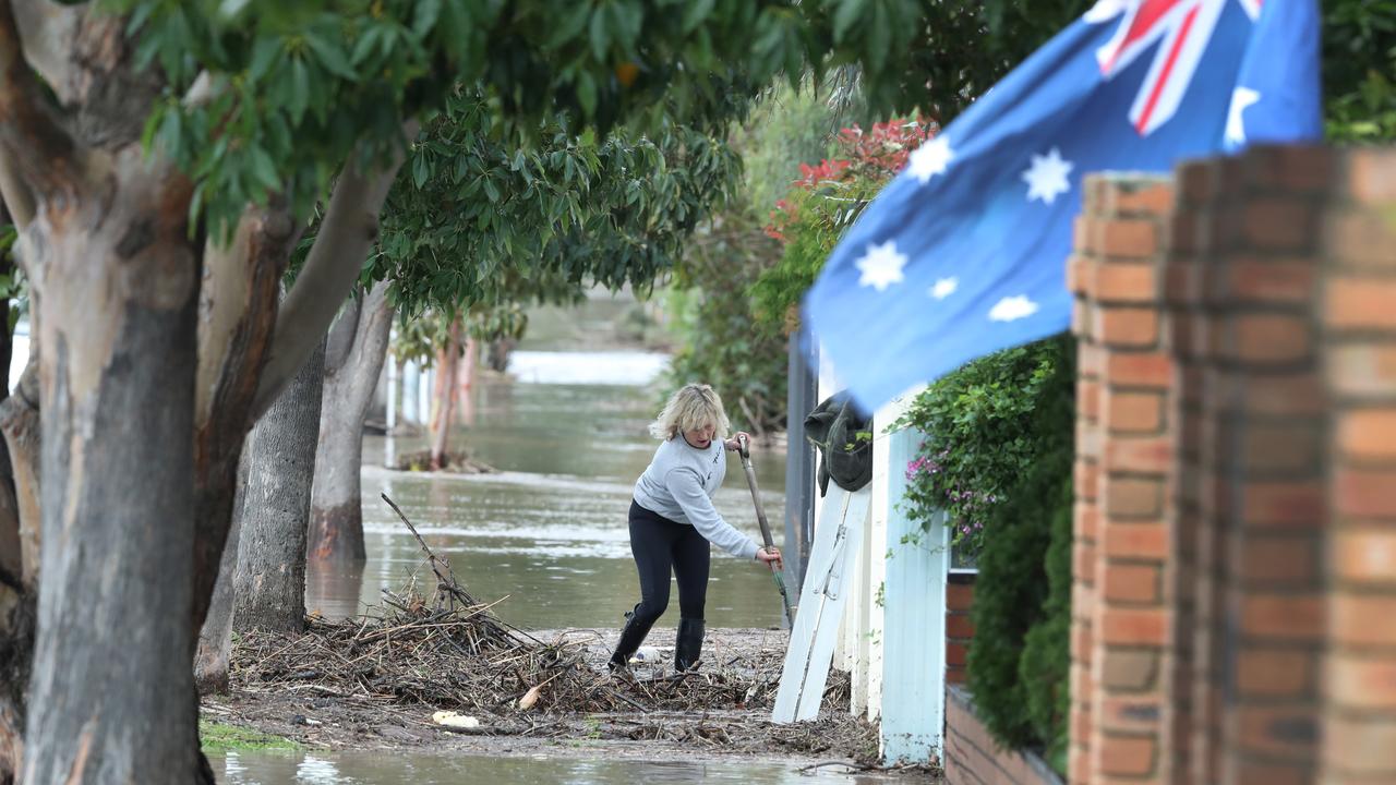 A woman starts to clean up in the Esplanades in Maribyrnong. Picture: NCA NewsWire / David Crosling