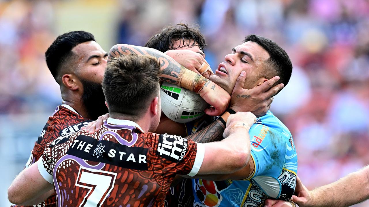 BRISBANE, AUSTRALIA - MAY 26: David Fifita of the Titans is wrapped up by the defence during the round 12 NRL match between Brisbane Broncos and Gold Coast Titans at Suncorp Stadium, on May 26, 2024, in Brisbane, Australia. (Photo by Bradley Kanaris/Getty Images)