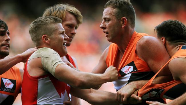 Dan Hannebery and Steve Johnson get up close and personal. Picture: Toby Zerna