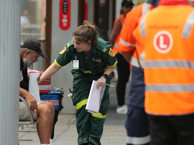 Paramedics attend to a sick passenger. Picture: Tim Hunter