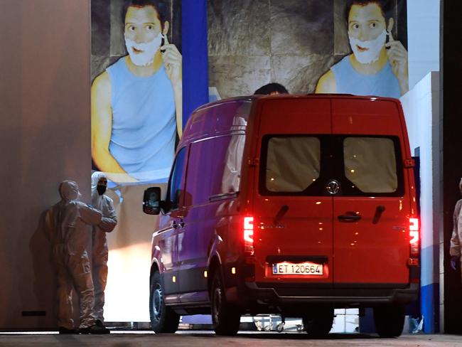 Members of the Spanish Army's Military Emergency Unit wearing protective suits stand as a van arrives at the Palacio de Hielo (Ice Palace) shopping mall. Picture: AFP