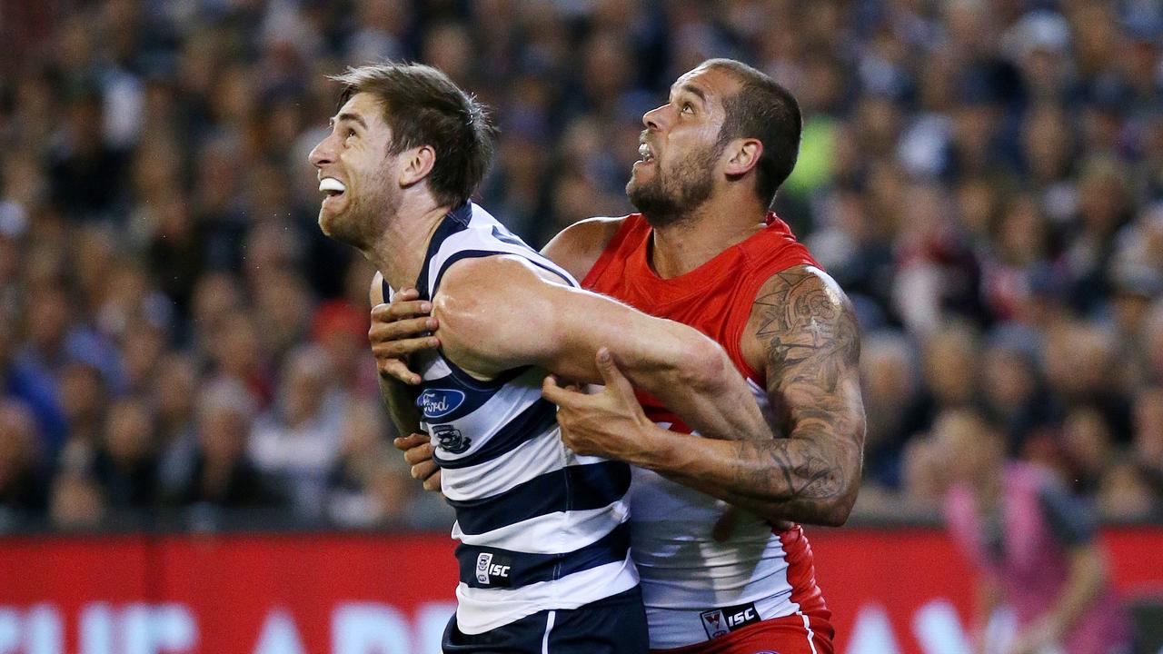 Geelong’s Tom Lonergan wrestles with Sydney superstar Lance Franklin.