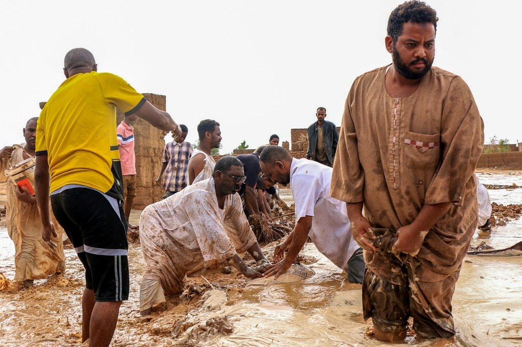 Men building a make-shift levee amid floods in Messawi, Sudan earlier this year