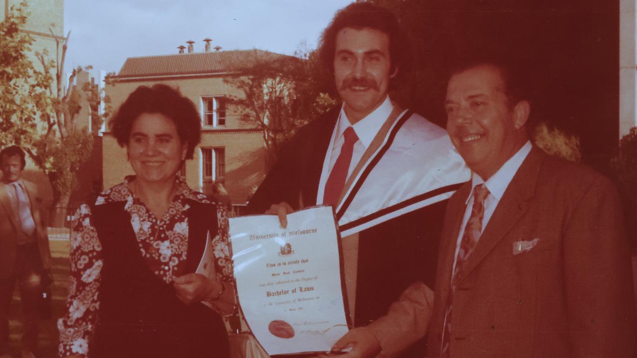 Mario with his parents at his law school graduation. Picture: Alex Coppel