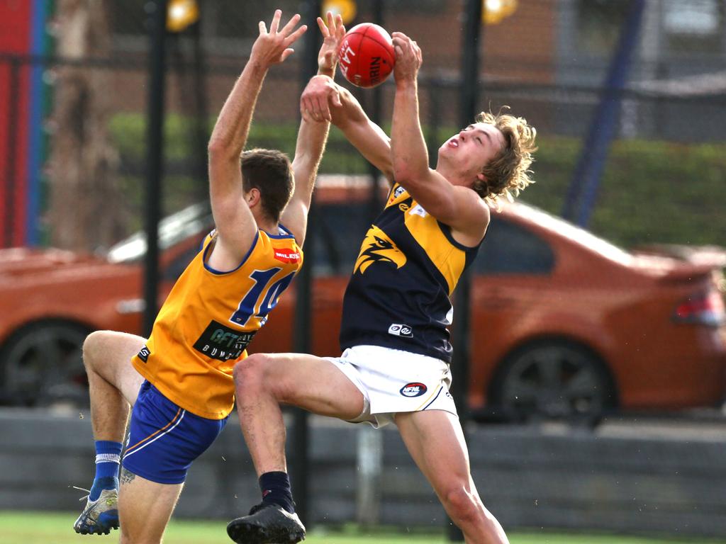 Northern: Whittlesea’s Brody Bell flies for the mark against Anthony Da Silva of Macleod. Picture: Stuart Milligan