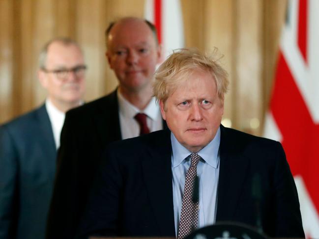 Chief Medical Adviser to the UK Government Chris Whitty, centre, looks on as UK PM Boris Johnson speaks to the media. Picture: AFP