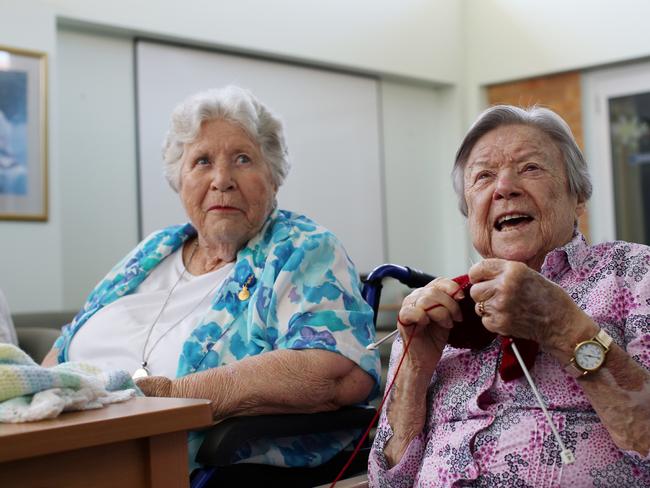 (L to R) Best friends, and residents, Joan Somerville and Joan Henderson of Allambie Heights Village aged care facility share a joke at their knitting group, which has since had to cancel its teacher due to COVID-19. Residents are adapting to changes set out by a government directive to reduce the spread of COVID-19. The elderly face an increased risk and vulnerability to the consequences of COVID-19. Friday 20 March 2020. Picture: Nikki Short