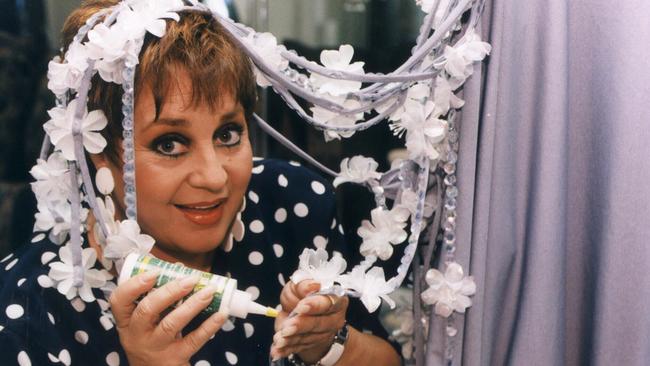 1999: Wills with sequin magnolias she was adding to her dress to wear to the Academy Awards, an event she attended annually for many years.