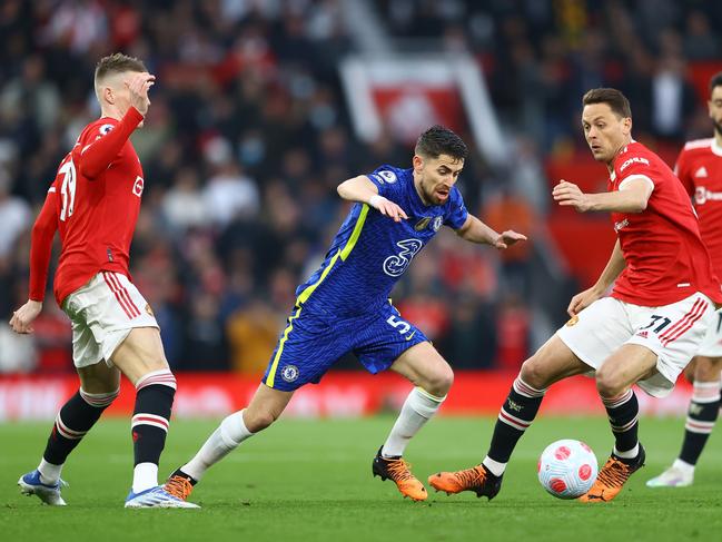 MANCHESTER, ENGLAND - APRIL 28: Jorginho of Chelsea cuts between Nemanja Matic (r) and Scott McTominay (l) of Manchester United during the Premier League match between Manchester United and Chelsea at Old Trafford on April 28, 2022 in Manchester, England. (Photo by Michael Steele/Getty Images)