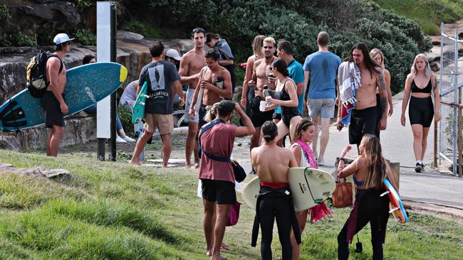 Large crowds exercising on the Bondi to Bronte walk — above the closed off beach areas — near MacKenzies Bay this morning. Picture: Adam Yip