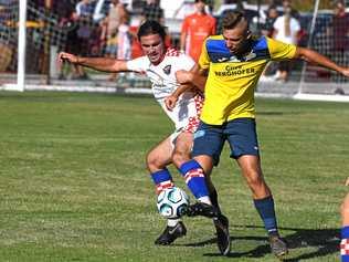 TIGHT BATTLE: Gold Coast Knights player Oskar Dillon (left) battles for possession of the ball with South West Queensland Thunder striker Anthony Grant. Picture: GCB - John Gass