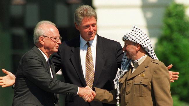 US President Bill Clinton, centre, presides over White House ceremonies marking the signing of the peace accord between Israel and the Palestinians with Israeli Prime Minister Yitzhak Rabin, left, and Palestinian leader Yasser Arafat in Washington in 1993.