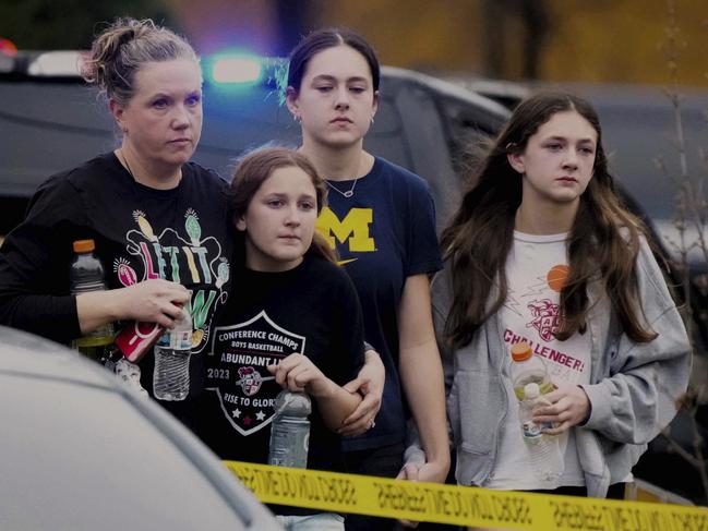 A family leaves the shelter after multiple injuries were reported following a shooting at the Abundant Life Christian School. Picture: AP