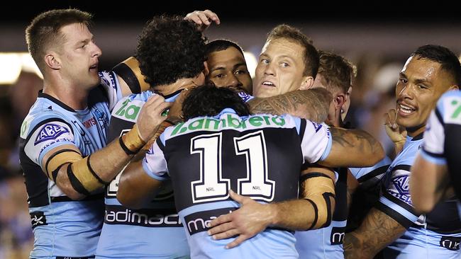 Sione Katoa celebrates with his Sharks teammates after scoring a try. Picture: Getty Images