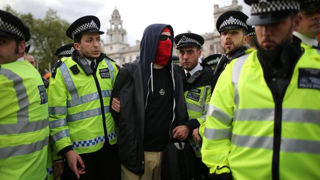 Police officers restrain a demonstrator during a protest at Parliament Square. Pic: Christopher Furlong/Getty Images.