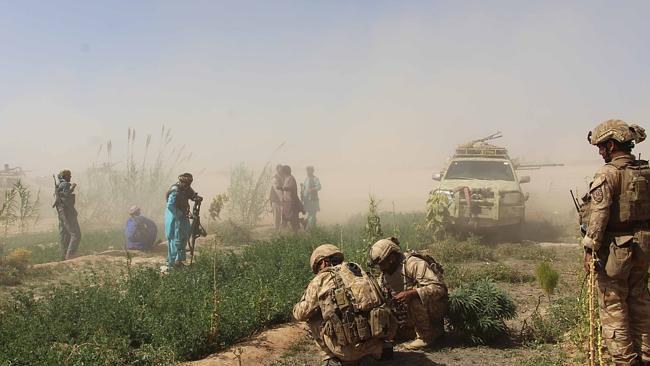 Afghan National Army commandos and militia forces take position in Helmand province yesterday.