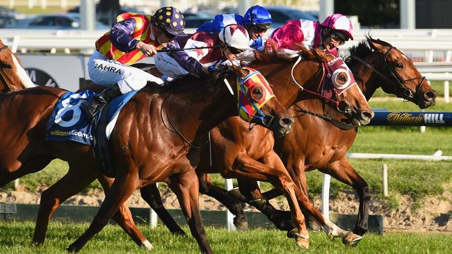 MELBOURNE, AUSTRALIA - SEPTEMBER 26: Craig Williams riding Stratum Star (ctr) defeats Damien Oliver riding Disposition (R) and Mark Zahra riding Under The Louvre (L) in Race 8, the Sir Rupert Clarke Stakes during Melbourne Racing at Caulfield Racecourse on September 26, 2015 in Melbourne, Australia. (Photo by Vince Caligiuri/Getty Images)