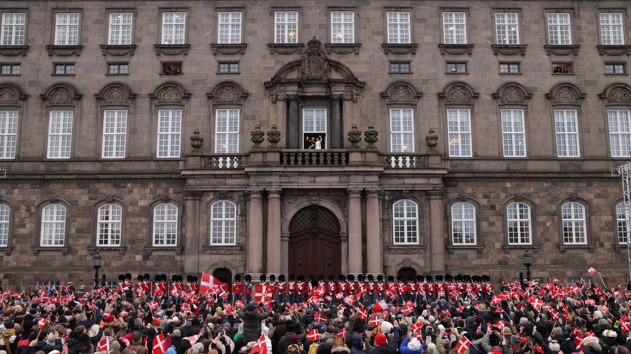 Danish King Frederik X and his wife Queen Mary of Denmark wave to the crowds after his proclamation by the Prime Minister, Mette Frederiksen on the balcony of Christiansborg Palace. Picture: Sean Gallup