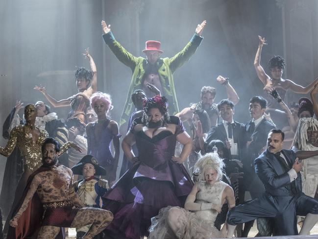 Settle, front and centre in the purple dress, as The Bearded Lady in The Greatest Showman.