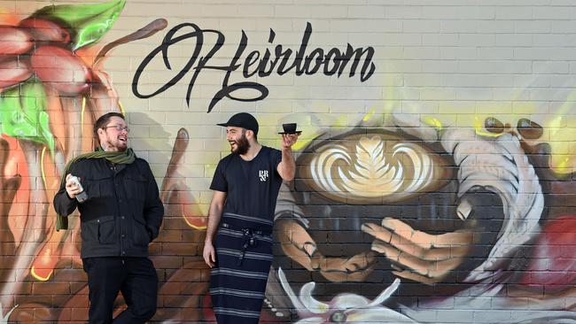 Visual artist Joe Quilter and cafe owner Marcel Ghabbar next to Quilter’s completed Heirloom Specialty Coffee wall mural in Mosman. Picture: Troy Snook