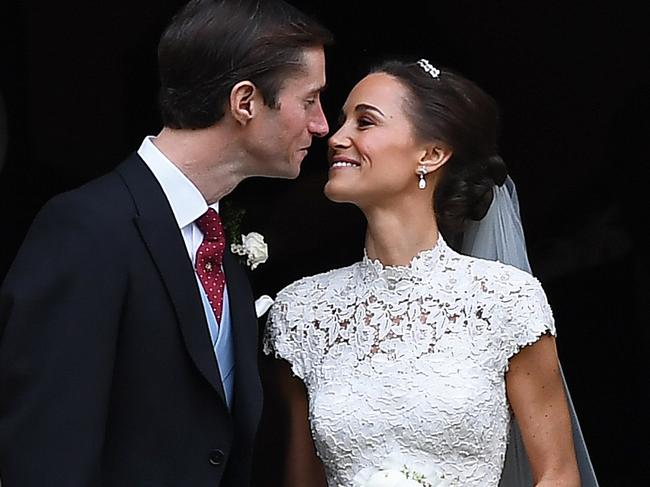 ENGLEFIELD GREEN, ENGLAND - MAY 20: Pippa Middleton kisses her new husband James Matthews, following their wedding ceremony at St Mark's Church as the bridesmaids and pageboys walk ahead on May 20, 2017 in Englefield Green, England.  (Photo by Justin Tallis - WPA Pool) ***BESTPIX***