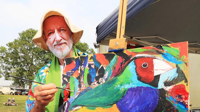 Artist Chris Degendhart with one of his striking paintings with will be for sale at the Murwillumbah Farmers Markets.