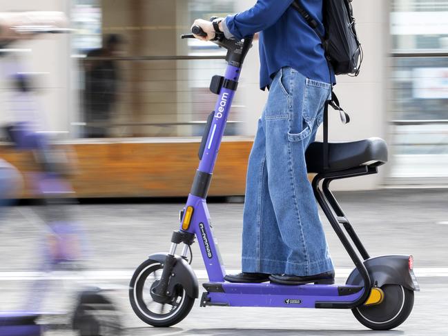 Hobart residents Bob Vincent and Heather Leetion on the new seated Beam e-scooters. Picture: Chris Kidd