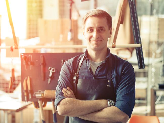 Leather craft workshop owner at his work place