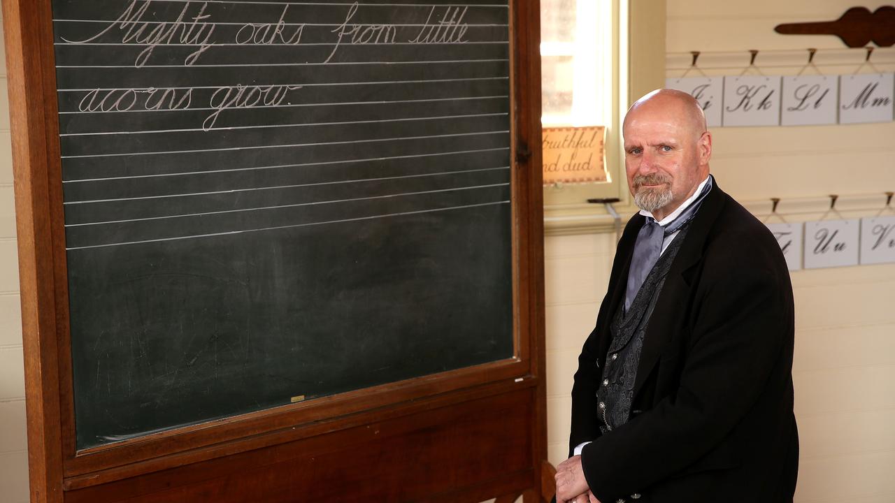 Peter Beckwith, who works as a teacher at Sovereign Hill, Ballarat, with some old-fashioned handwriting on the board. Picture: Andy Rogers