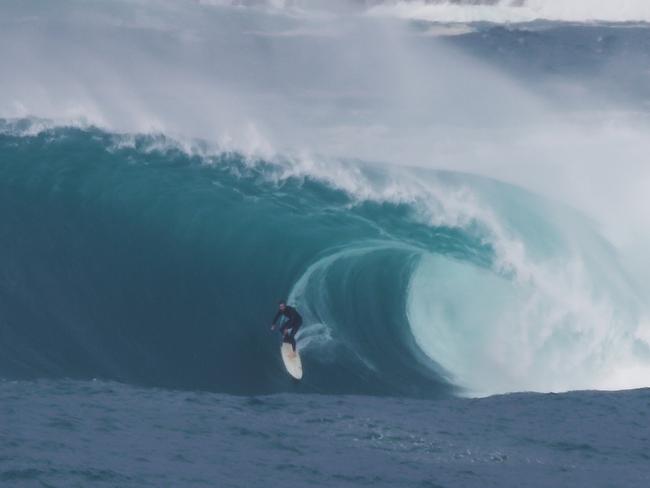 ONE TIME WEB USE ONLY - FEES APPLY FOR REUSE - Surfer catches huge waves in Sydney on July 15 2020. Picture: Spencer Frost Films