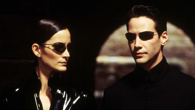 Carrie-Anne Moss and Keanu Reeves in <i>The Matrix</i>.