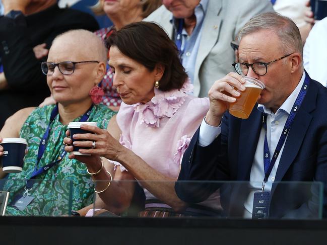 Tennis Albo.... The PM enjoys a frothie at the tennis. Picture: Michael Klein