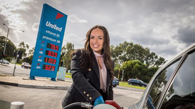 Adele Mirabella fills up with cheap fuel at a United Petrol Station in Kew. Picture: Jake Nowakowski