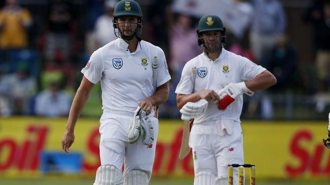 Theunis de Bruyn, left, leaves the ground as wicketkeeper Tim Paine looks on. Picture: AFP