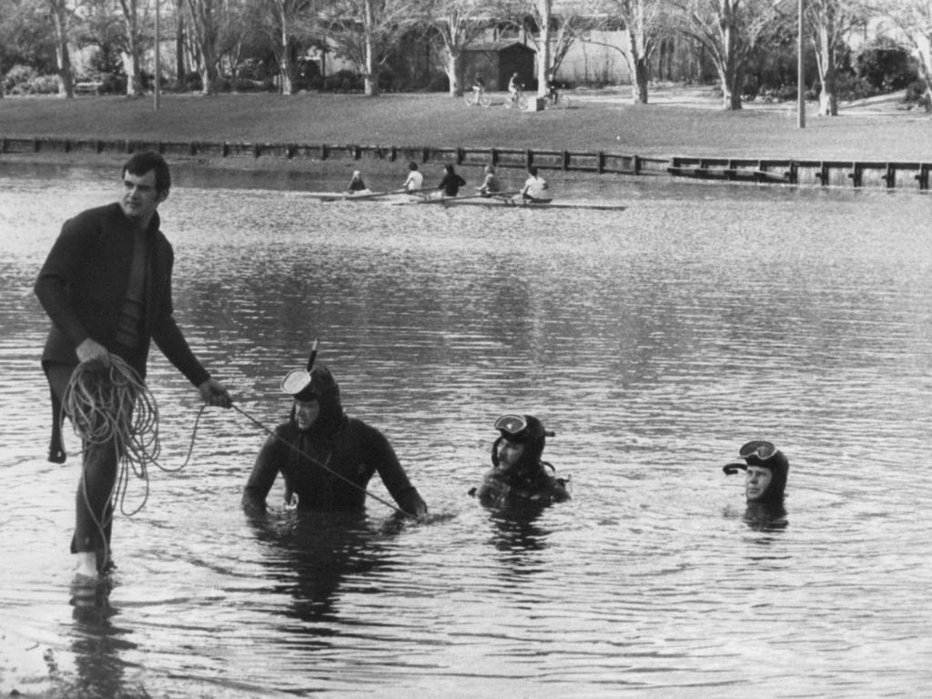 Police divers search the Torrens for the two girls.