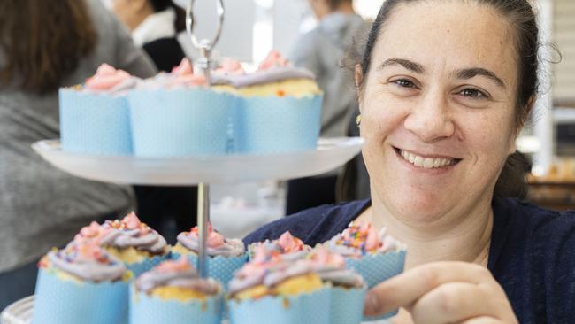 At Panania North Public School, Louise Anthony shows off some impressive cupcakes at the schools cake stall. Picture: AAP